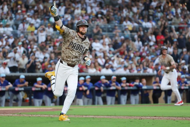 Jake Cronenworth #9 of the San Diego Padres celebrates after hitting a walk-off single against the Texas Rangers during the tenth inning at Petco Park on Friday, July 4, 2025 in San Diego, CA. (Meg McLaughlin / The San Diego Union-Tribune)