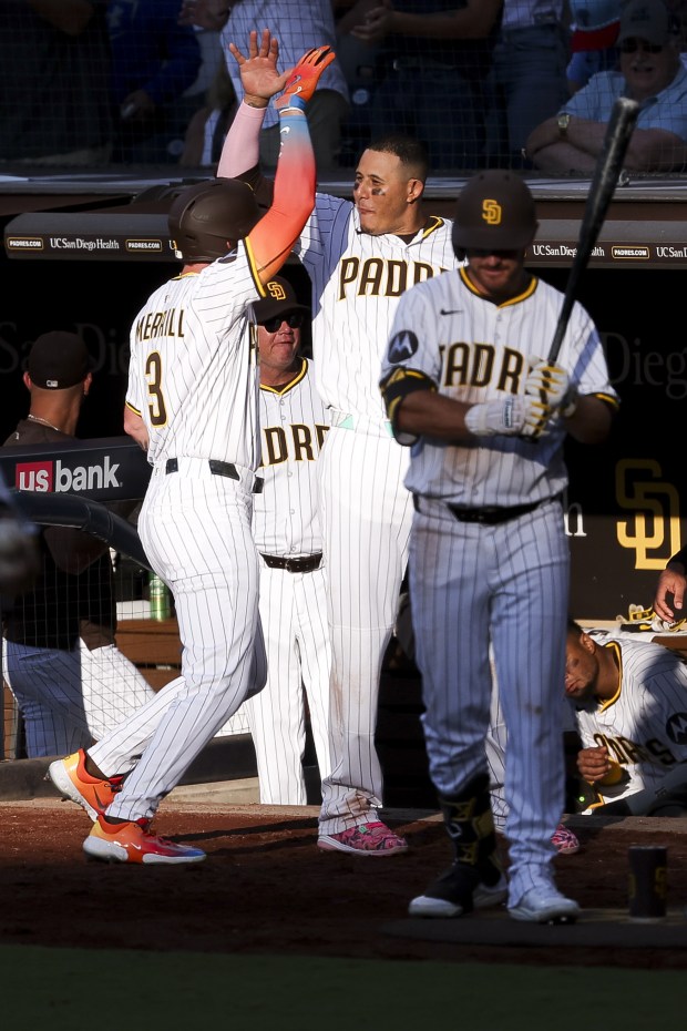 Jackson Merrill #3 of the San Diego Padres and Manny Machado #13 celebrate after Merrill's home run against the Philadelphia Phillies during the sixth inning at Petco Park on Saturday, July 12, 2025 in San Diego, CA. (Meg McLaughlin / The San Diego Union-Tribune)