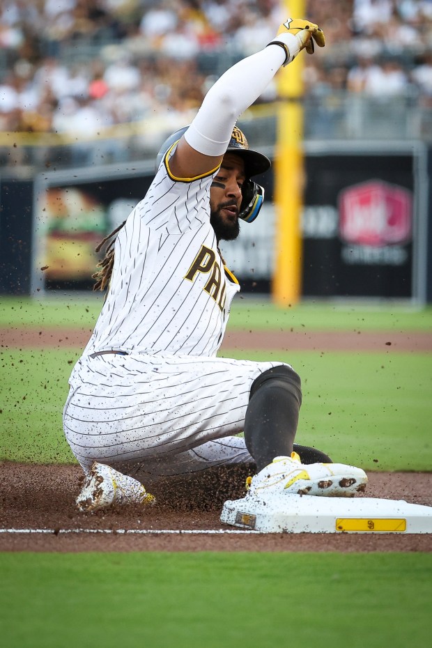 Fernando Tatis Jr. #23 of the San Diego Padres slides into third base against the New York Mets during the first inning at Petco Park on Tuesday, July 29, 2025 in San Diego, CA. (Meg McLaughlin / The San Diego Union-Tribune)