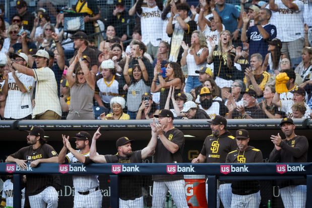 San Diego Padres dugout celebrates after Jackson Merrill #3 double against the New York Mets during the first inning at Petco Park on Tuesday, July 29, 2025 in San Diego, CA. (Meg McLaughlin / The San Diego Union-Tribune)
