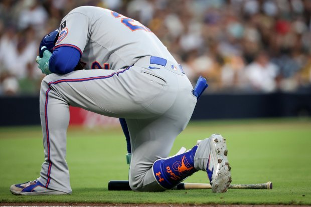 Juan Soto #22 of the New York Mets kneels on the ground after fouling a ball off his leg during the fourth inning against the San Diego Padres at Petco Park on Tuesday, July 29, 2025 in San Diego, CA. (Meg McLaughlin / The San Diego Union-Tribune)
