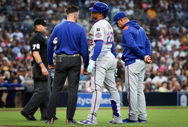 Juan Soto #22 of the New York Mets speaks with a trainer after fouling a ball off his leg during the fourth inning against the San Diego Padres at Petco Park on Tuesday, July 29, 2025 in San Diego, CA. (Meg McLaughlin / The San Diego Union-Tribune)