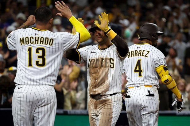 Manny Machado #13 of the San Diego Padres and Jose Iglesias #7 celebrate after Iglesias' run scored against the New York Mets during the seventh inning at Petco Park on Tuesday, July 29, 2025 in San Diego, CA. (Meg McLaughlin / The San Diego Union-Tribune)