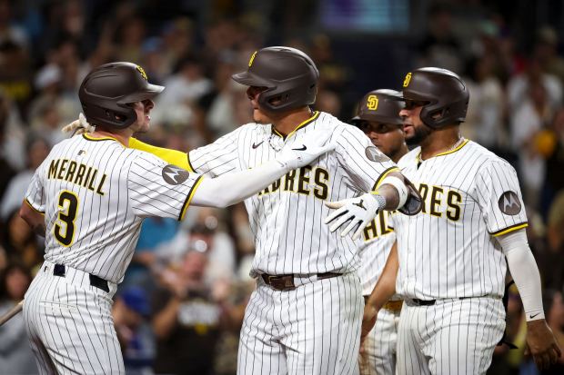 Manny Machado #13 of the San Diego Padres celebrates with Jackson Merrill #3 after Machado's home run against the New York Mets during the seventh inning at Petco Park on Tuesday, July 29, 2025 in San Diego, CA. (Meg McLaughlin / The San Diego Union-Tribune)