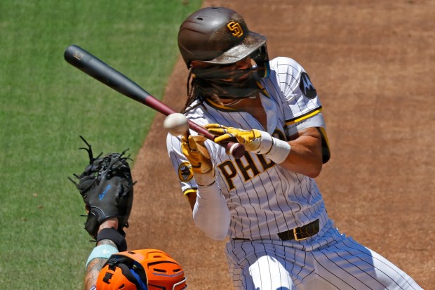 Fernando Tatis Jr. #23 of the San Diego Padres is hit by a pitch on the hand in second inning against the New York Mets at Petco Park on July 30, 2025 in San Diego, CA. (K.C. Alfred / The San Diego Union-Tribune)