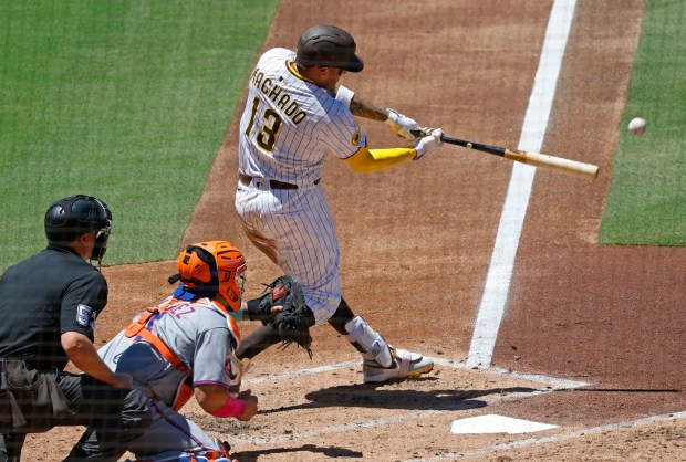 Manny Machado #30 of the San Diego Padres hits a two-run single in second inning against the New York Mets at Petco Park on July 30, 2025 in San Diego, CA. (K.C. Alfred / The San Diego Union-Tribune)