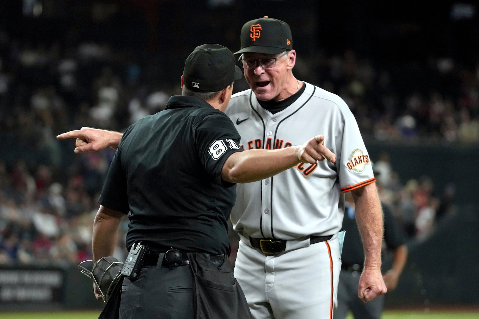 San Francisco Giants manager Bob Melvin has words with home plate umpire Quinn Wolcott (81) after getting ejected from the game in the ninth inning during a baseball game against the Arizona Diamondbacks, Monday, June 30, 2025, in Phoenix. (AP Photo/Rick Scuteri)