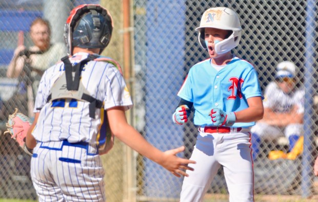 Nottingham's Owen McWhorter, right, reacts after he scored a run by avoiding the tag of Sunnybrae catcher Hank Little, left, in the first inning during the District 12 Little League Baseball championship round on Saturday evening at Ed Nevius Field in Hamilton Twp. (Kyle Franko/ Trentonian Photo)