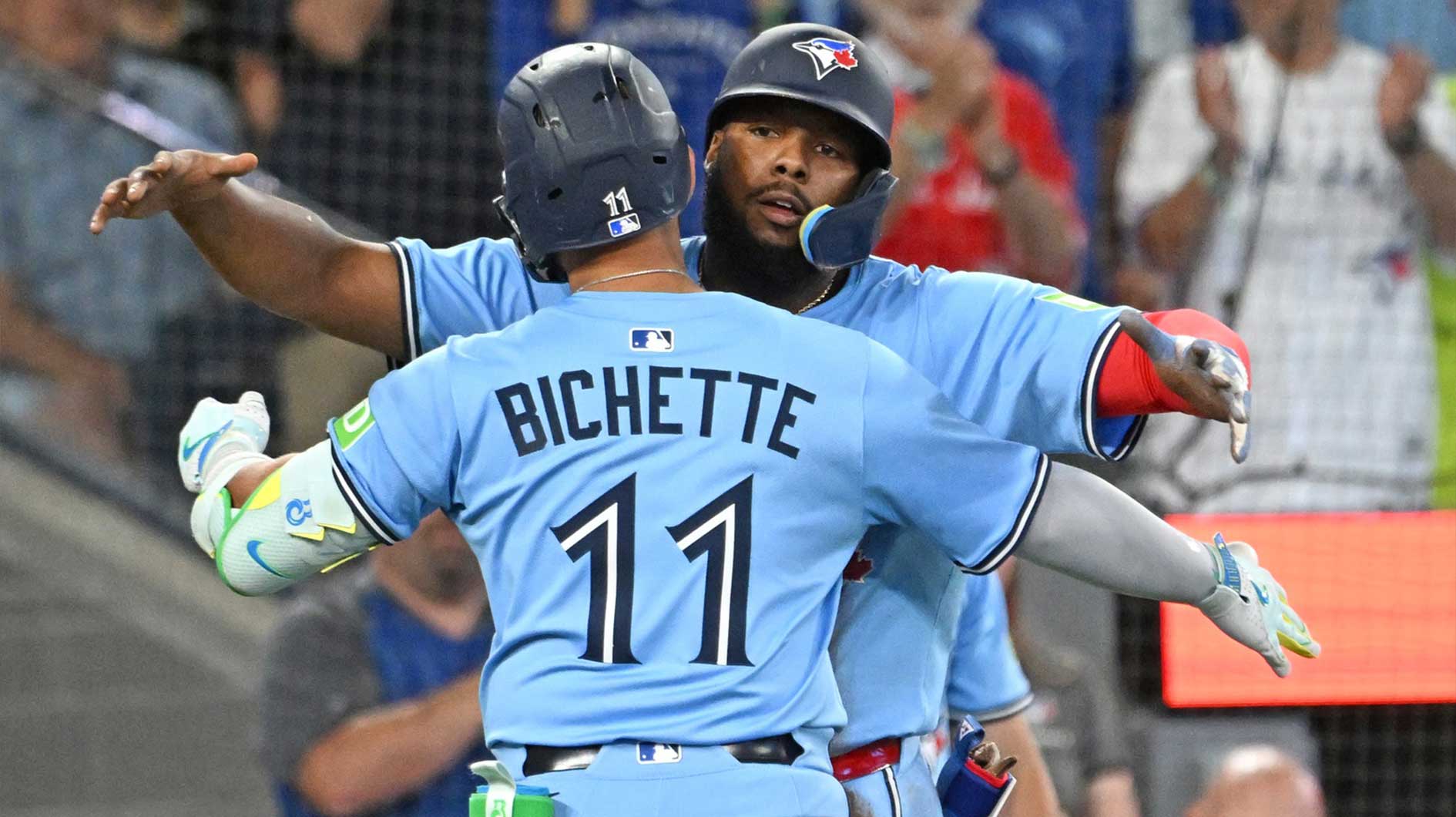 Toronto Blue Jays shortstop Bo Bichette (11) is greeted by first baseman Vladimir Guerrero Jr. (27) after hitting a two run home run against the New York Yankees in the seventh inning at Rogers Centre.