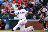 Texas Rangers third baseman Adrian Beltre ends up on his knees after a foul at the hands of...