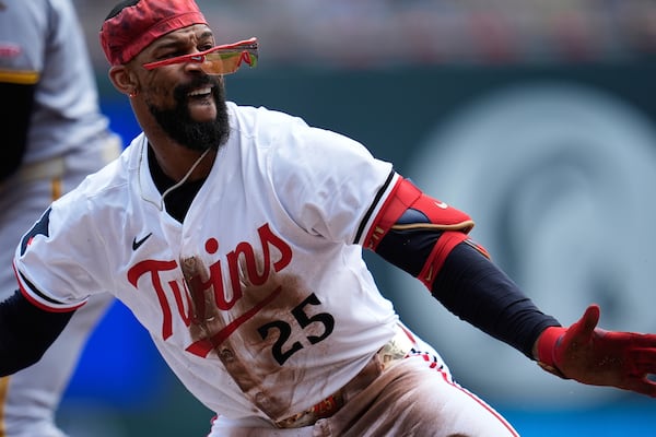 Minnesota Twins' Byron Buxton (25) celebrates after hitting a triple during the second inning of a baseball game against the Pittsburgh Pirates, Saturday, July 12, 2025, in Minneapolis. (AP Photo/Abbie Parr)