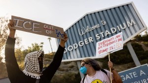 A small group of demonstrators protests outside the entrance of Dodger Stadium (Credit: ETIENNE LAURENT / AFP)