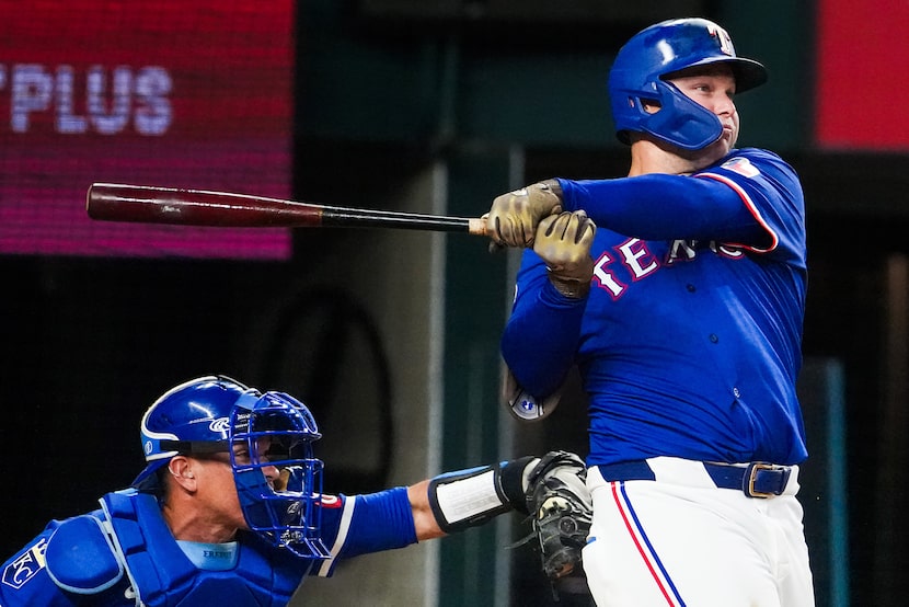 Texas Rangers designated hitter Joc Pederson watches the flight of a three-run home run...