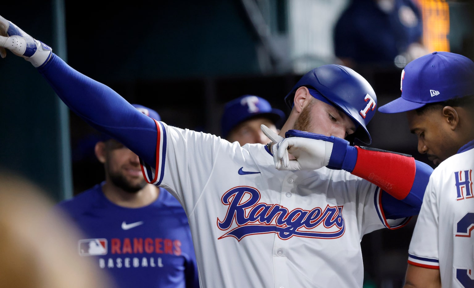 Texas Rangers Jonah Heim (28) gestures in the dugout after scoring on a Jake Burger single...