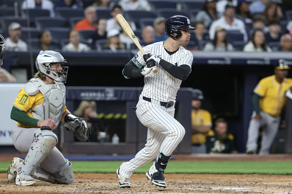 Jun 27, 2025; Bronx, New York, USA; New York Yankees left fielder Cody Bellinger (35) hits an RBI single in the third inning against the Athletics at Yankee Stadium. Mandatory Credit: Wendell Cruz-Imagn Images