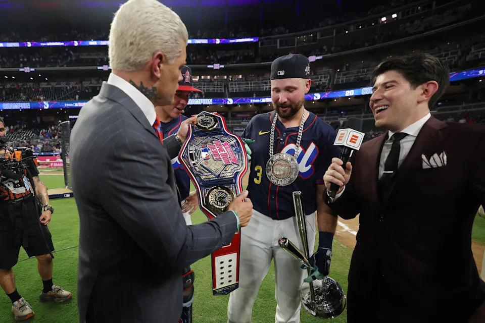 ATLANTA, GEORGIA - JULY 14: Cal Raleigh #29 of the Seattle Mariners receives the championship belt from professional wrestler Cody Rhodes after winning the Home Run Derby at Truist Park on July 14, 2025 in Atlanta, Georgia.  (Photo by Jamie Squire/Getty Images)