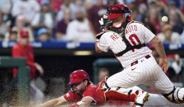 Los Angeles Angels first base LaMonte Wade Jr. fields a single by Philadelphia Phillies' J.T. Realmuto during the sixth inning of a baseball game Saturday, July 19, 2025, in Philadelphia. (AP Photo/Matt Slocum)