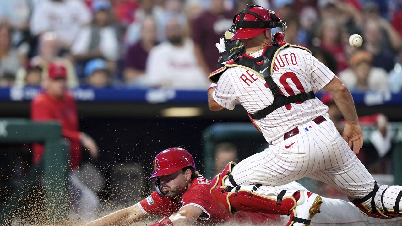 Los Angeles Angels first base LaMonte Wade Jr. fields a single by Philadelphia Phillies' J.T. Realmuto during the sixth inning of a baseball game Saturday, July 19, 2025, in Philadelphia. (AP Photo/Matt Slocum)