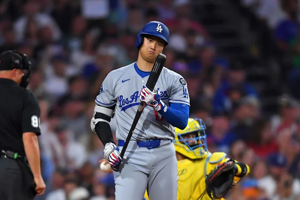 Dodgers star Shohei Ohtani examines his bat before striking out in the fourth inning Saturday.