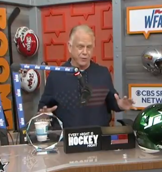 Man in American flag sweater on hockey night show.