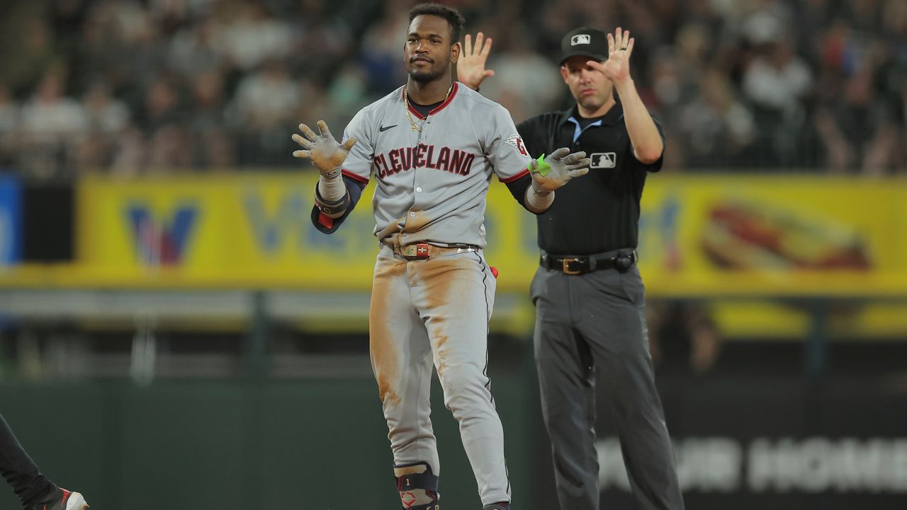 Cleveland Guardians' Angel Martínez, left, celebrates after hitting an RBI double during the seventh inning in the second baseball game of a doubleheader against the Chicago White Sox, Friday, July 11, 2025, in Chicago.