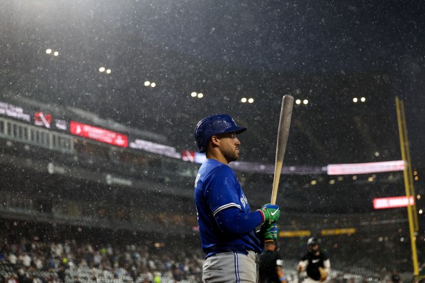 Toronto Blue Jays outfielder George Springer (4) stands in the rain before a rain delay is called during the seventh inning against the Chicago White Sox at Rate Field Tuesday July 8, 2025, in Chicago. (Armando L. Sanchez/Chicago Tribune)