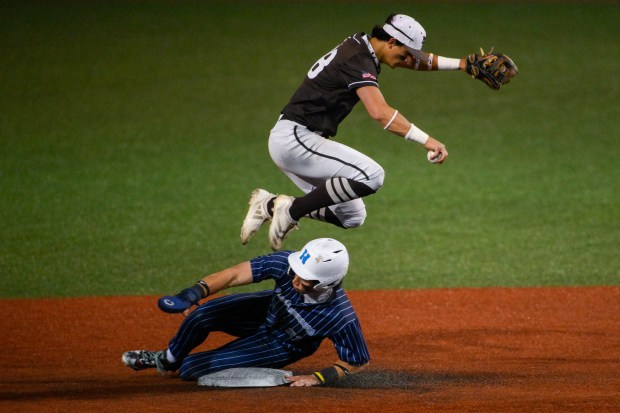 Mount Carmel's Joey Ireland jumps over Nazareth's Jaden Fauske as Fauske slides into second base during a Class 4A Reavis Sectional semifinal at Triton College on June 4, 2025, in River Grove. (Andrew Burke-Stevenson/for the Daily Southtown)