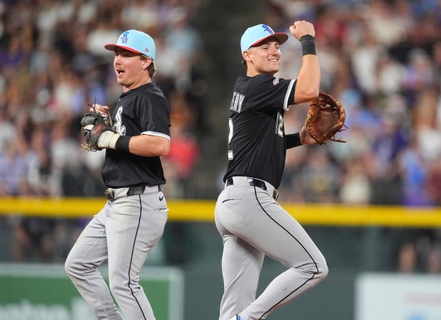 White Sox second baseman Chase Meidroth, left, and shortstop Colson Montgomery celebrate after defeating the Rockies on Friday, July 4, 2025, in Denver. (AP Photo/David Zalubowski)