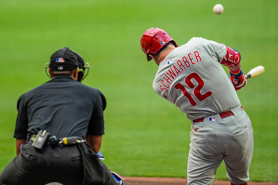 Philadelphia Phillies left fielder Kyle Schwarber (12) hits a double against the Atlanta BravesDale Zanine-Imagn Images