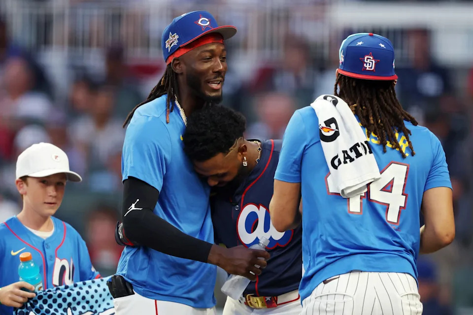 (L to R) Elly De La Cruz #44 of the Cincinnati Reds, Junior Camerino #13 of the Tampa Bay Rays, and Fernando Tatis Jr. #23 of the San Diego Padres react during the Home Run Derby at Truist Park on July 14, 2025 in Atlanta, Georgia.