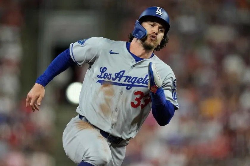 Los Angeles Dodgers' James Outman rounds third base to score on a double hit by Will Smith during the ninth inning of a baseball game against the Cincinnati Reds, Tuesday, July 29, 2025, in Cincinnati. (AP Photo/Carolyn Kaster)