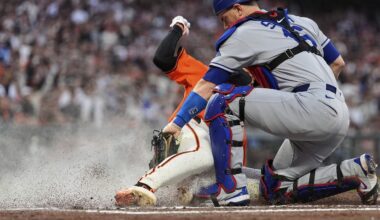 Los Angeles Dodgers catcher Will Smith, right, tags out San Francisco Giants' Jung Hoo Lee at home to end the fourth inning of a baseball game Friday, July 11, 2025, in San Francisco. (AP Photo/Godofredo A. Vásquez)