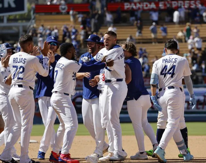 LOS ANGELES, CA - JULY 23, 2025: Dodger players celebrate Freddy Freeman's walk-off single that gave the Dodgers a 4-3 win over the Minnesota Twins at Dodger Stadium on July 23, 2025 in Los Angeles, California.(Gina Ferazzi / Los Angeles Times)