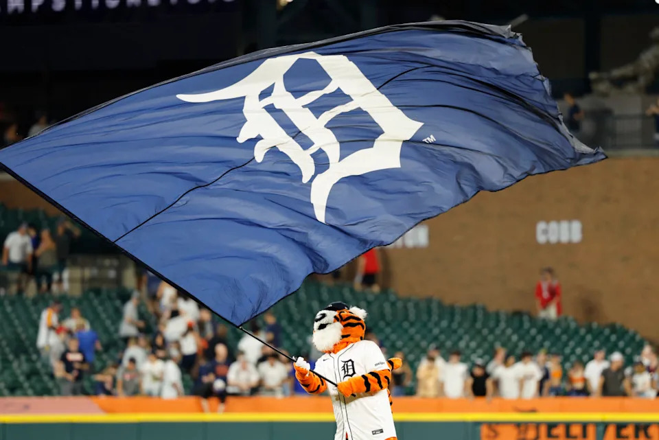 Detroit Tigers Mascot Paws waves the team flag at Comerica Park.© Rick Osentoski-Imagn Images