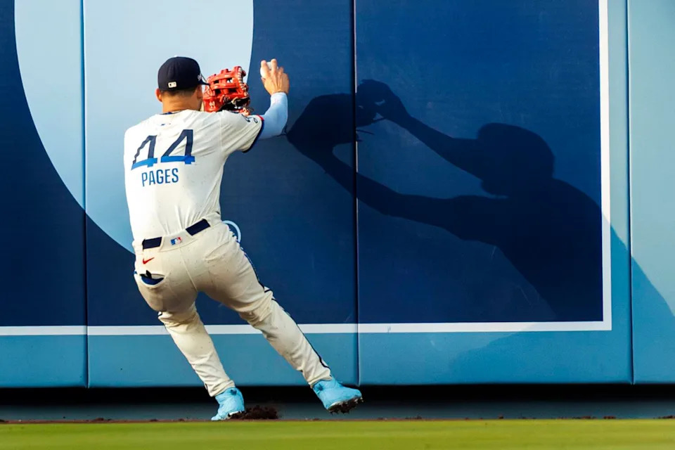 Dodgers center fielder Andy Pages runs into the wall after catching a sacrifice fly by Milwaukee's Andrew Vaughn.