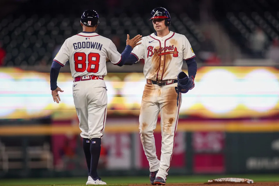 Atlanta Braves third baseman Austin Riley (27) celebrates after an RBI double with first base coach Tom Goodwin (88)Brett Davis-Imagn Images