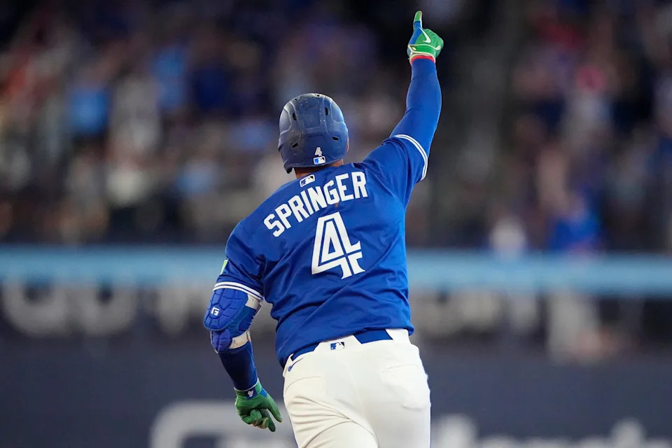 Jul 3, 2025; Toronto, Ontario, CAN; Toronto Blue Jays designated hitter George Springer (4) celebrates as he runs the bases on his two run home run against the New York Yankees during the eighth inning at Rogers Centre. Mandatory Credit: John E. Sokolowski-Imagn Images