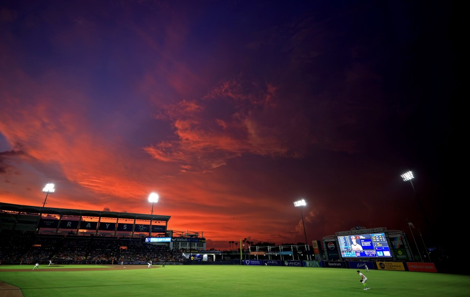 George M. Steinbrenner Field at sunset during a baseball game.