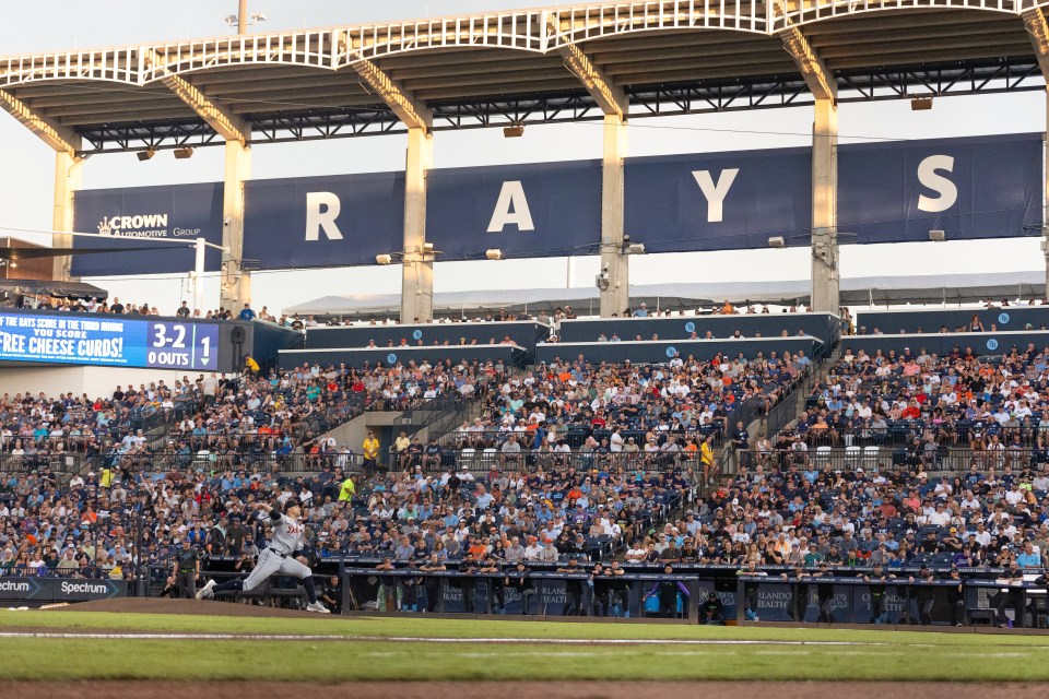 Baseball pitcher pitching in a stadium.
