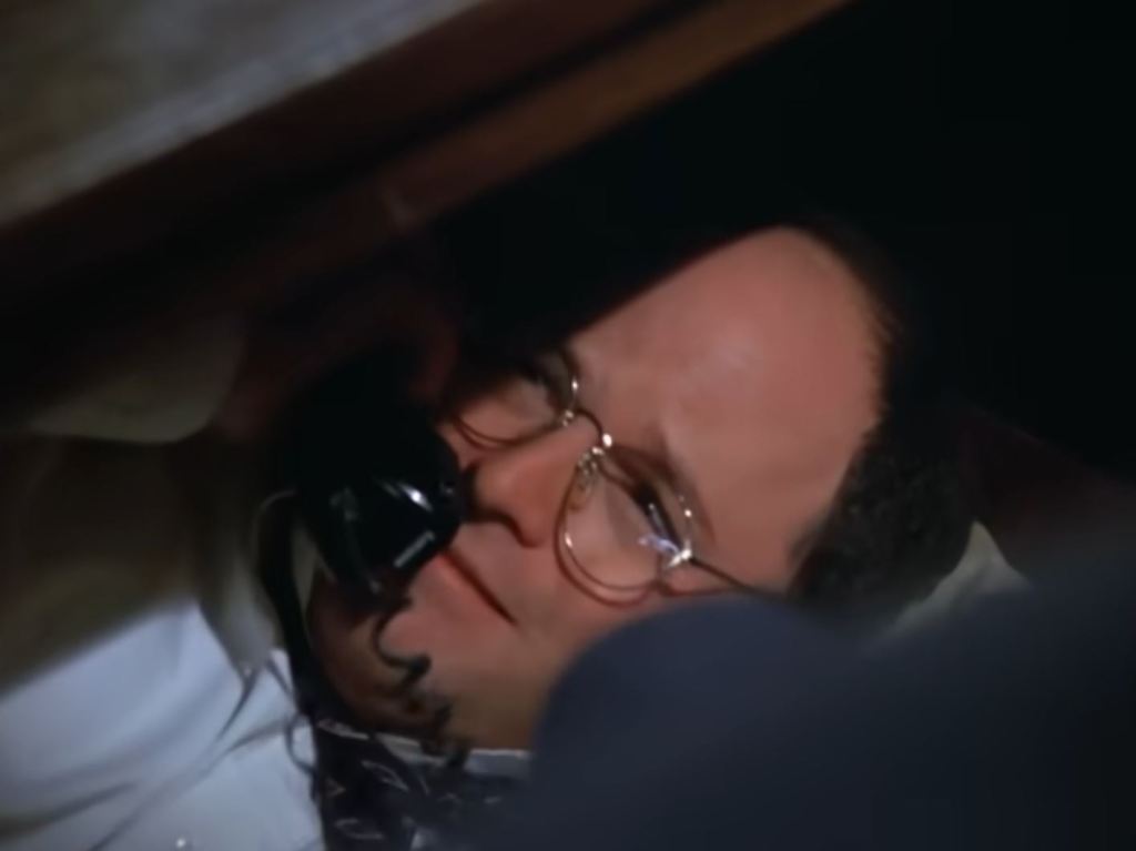 George Costanza under his desk in "Seinfeld."