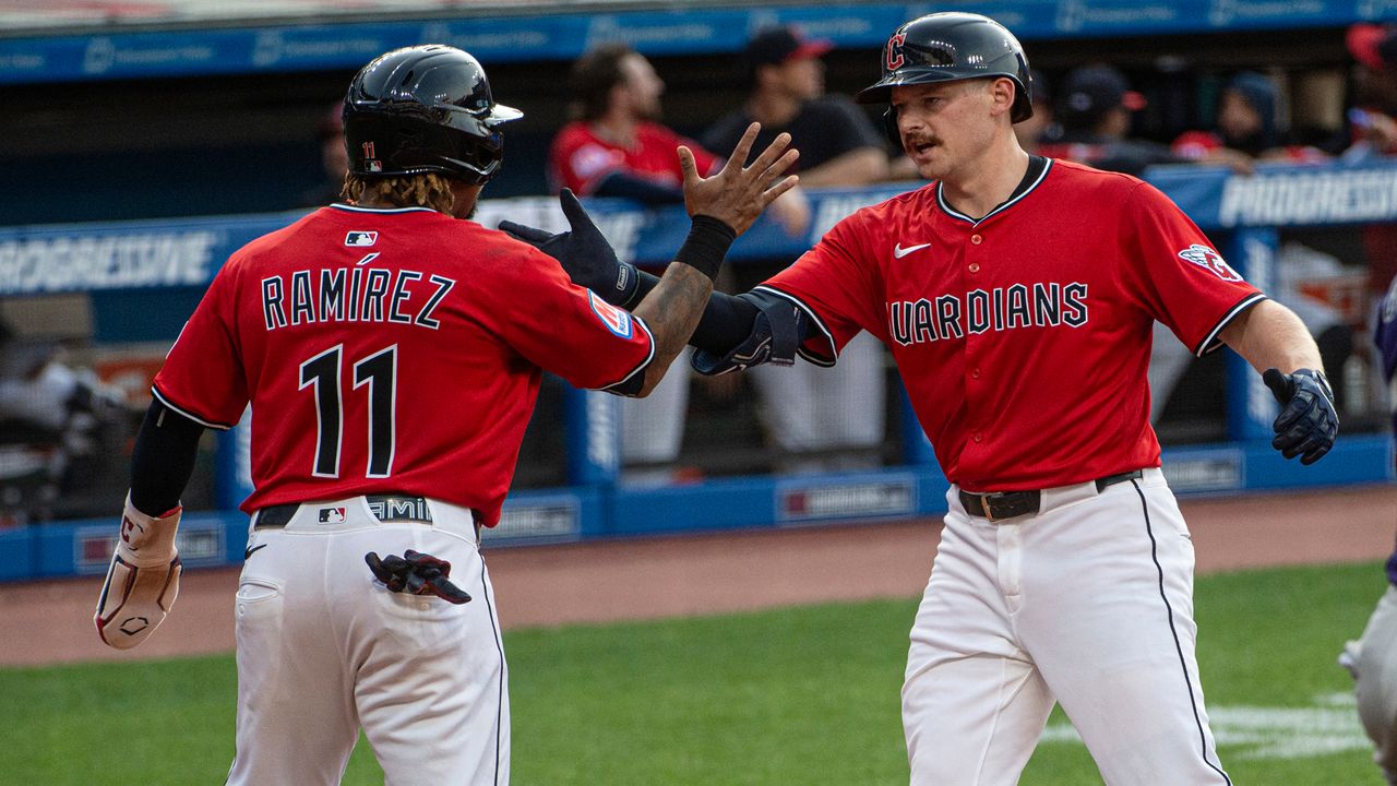 Colorado Rockies' Orlando Arcia (11) is tagged out between third base and home plate by Cleveland Guardians first baseman Carlos Santana, right, in the fifth inning of a baseball game in Cleveland, Monday, July 28, 2025. (AP Photo/Sue Ogrocki)