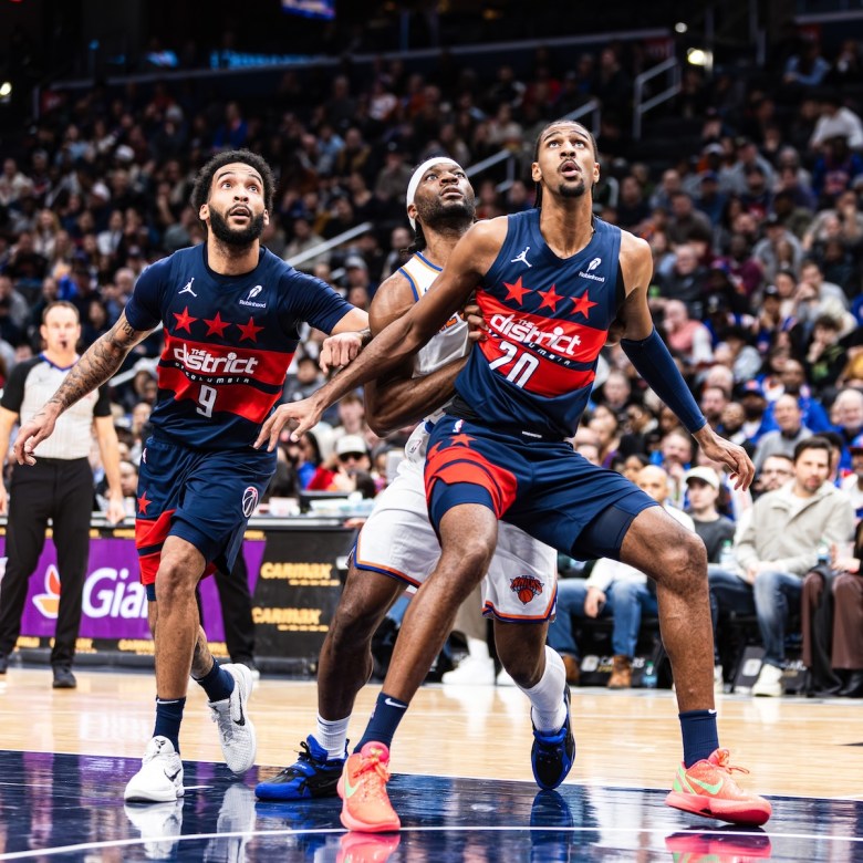 Alex Sarr (#20) boxes out New York Knicks forward Precious Achiwa on the free throw line. (Jonae Guest/The Washington Informer)