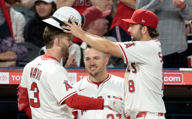 The Angels’ Taylor Ward, left, celebrates with teammates Nolan Schanuel,...
