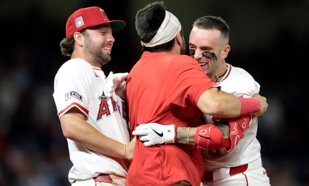 The Angels’ Zach Neto, right, celebrates with teammates Nolan Schanuel,...