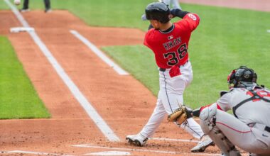 Cleveland Guardians' Steven Kwan (38) hits a double off Boston Red Sox starting pitcher Tanner Houck as catcher Blake Sabol looks on during first inning in the first baseball game of a doubleheader Saturday, April 26, 2025. in Cleveland. (AP Photo/Phil Long)