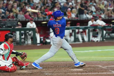 Mar 27, 2025; Phoenix, Arizona, USA; Chicago Cubs catcher Miguel Amaya (9) hits a three RBI double against the Arizona Diamondbacks during the fifth inning at Chase Field. Mandatory Credit: Joe Camporeale-Imagn Images