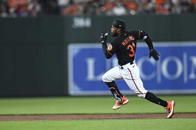 Baltimore Orioles&apos; Cedric Mullins races to third on a triple against the Pittsburgh Pirates during the fifth inning of a baseball game Friday, May 12, 2023, in Baltimore. (AP Photo/Gail Burton)