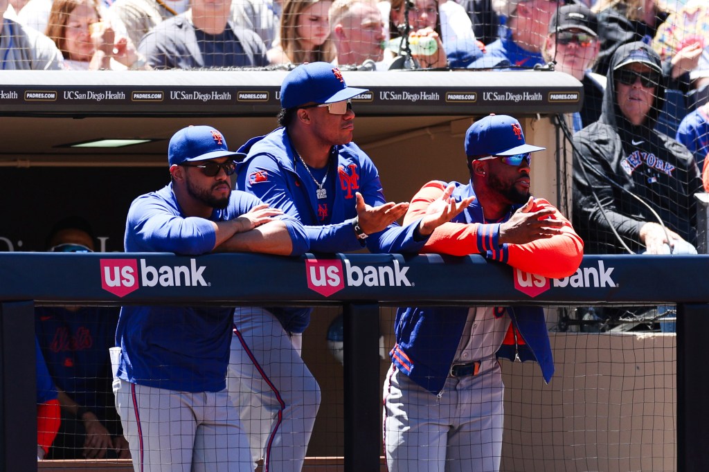 New York Mets baseball players in the dugout.