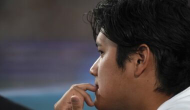 Los Angeles Dodgers' Shohei Ohtani watches from the dugout during the fourth inning of a baseball game against the Milwaukee Brewers, Friday, July 18, 2025, in Los Angeles. (AP Photo/Mark J. Terrill)