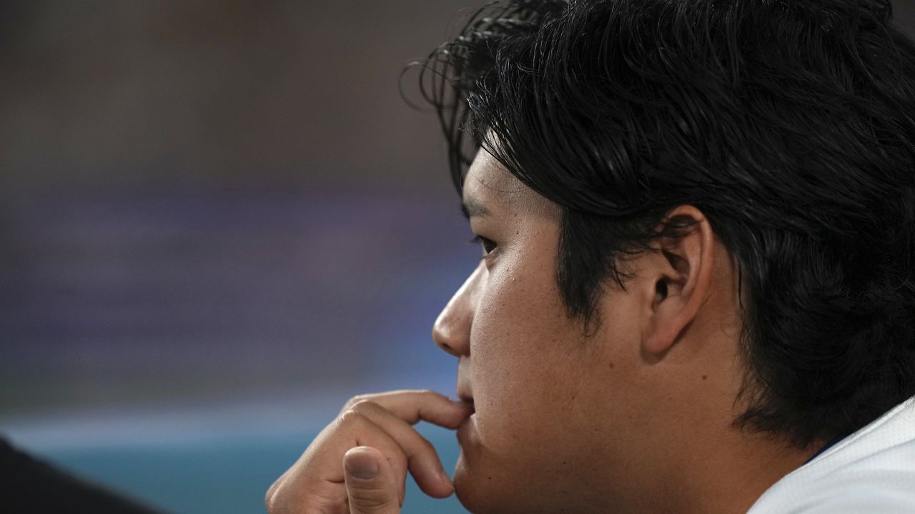 Los Angeles Dodgers' Shohei Ohtani watches from the dugout during the fourth inning of a baseball game against the Milwaukee Brewers, Friday, July 18, 2025, in Los Angeles. (AP Photo/Mark J. Terrill)